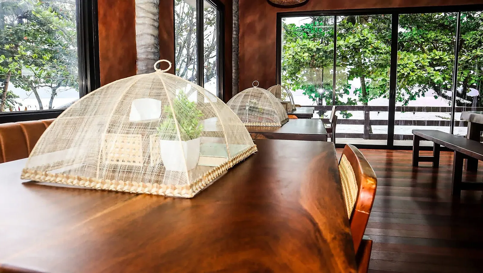 Dining table set with the sea view through windows