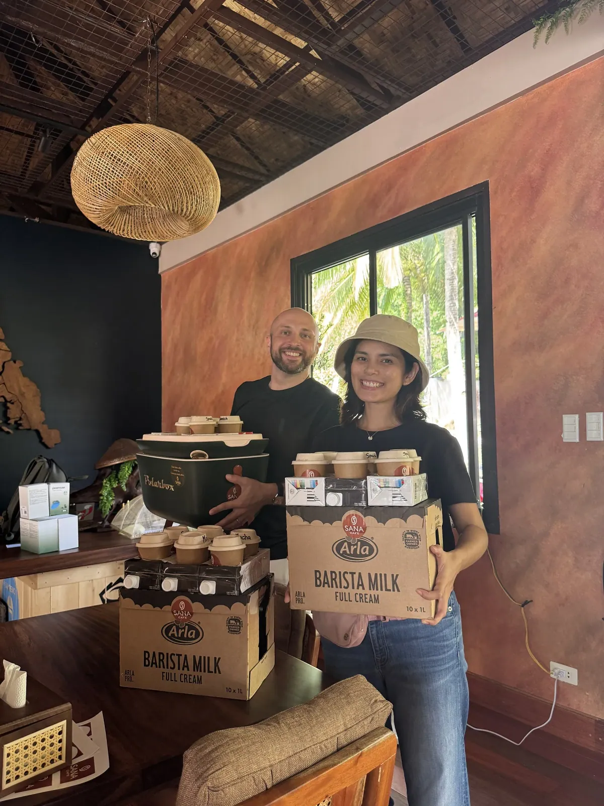 Sasha and Natasha restocking Arla barista milk — hands-on at SANA