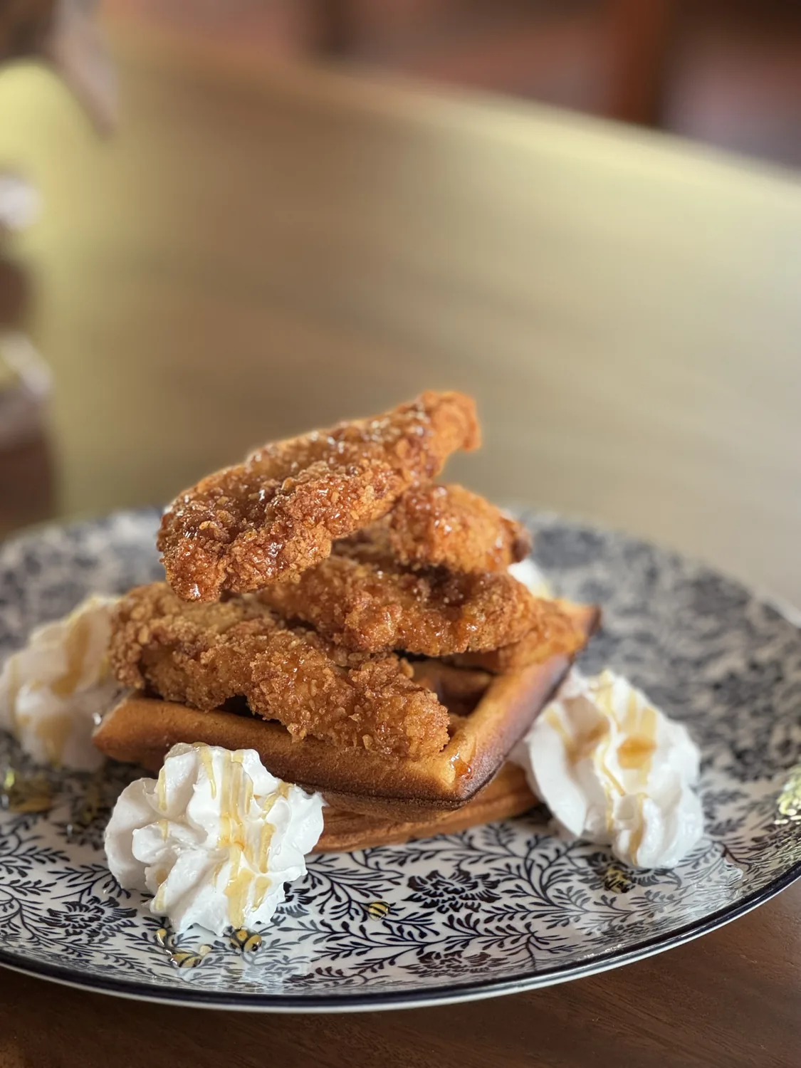Chicken and waffles drizzled with honey at SANA Cafe