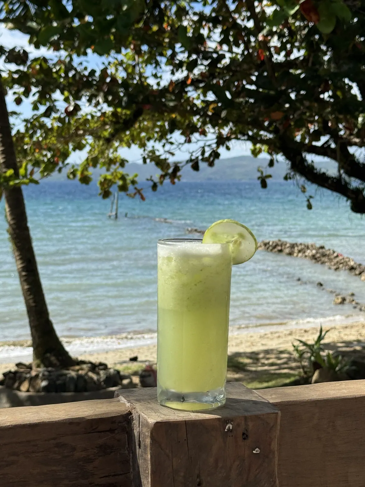 Cucumber Lemon refresher with the ocean as the backdrop