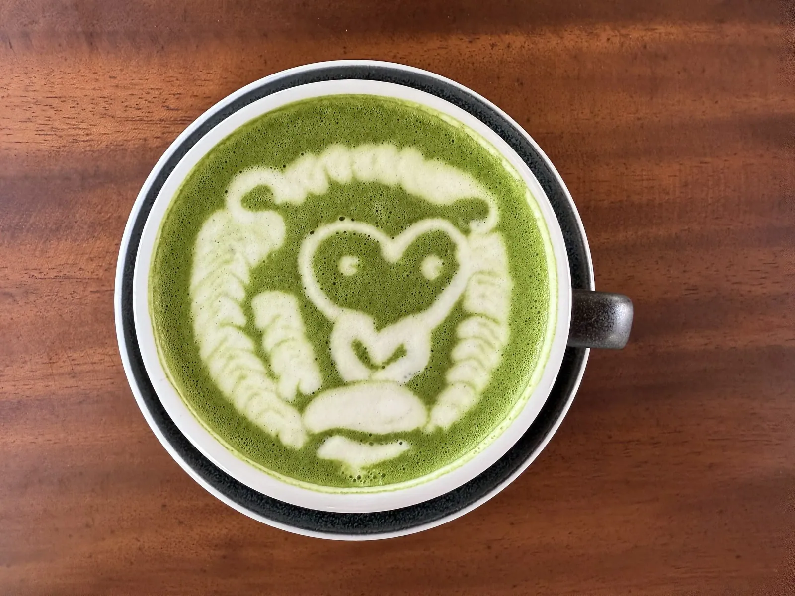 Matcha latte with playful character art