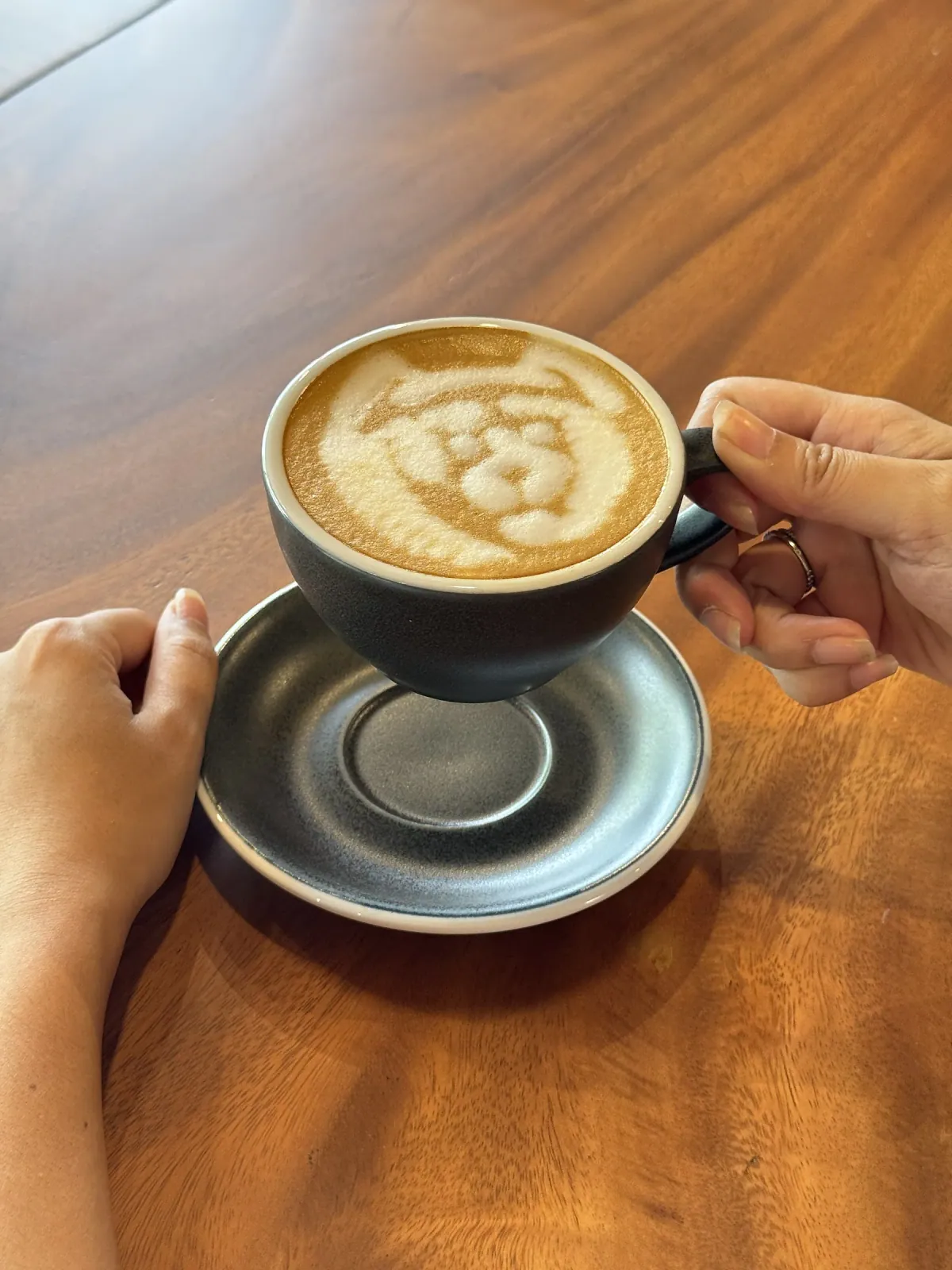 Heart latte art in a hand-thrown cup