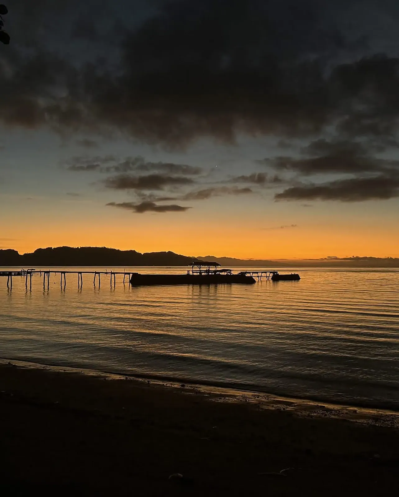Dinagat pier at sunset — your view from SANA