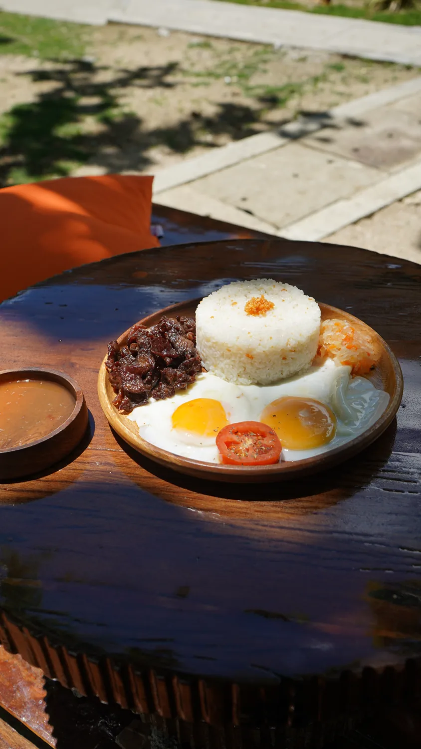 Filipino tapsilog breakfast plate in the sun at SANA Cafe
