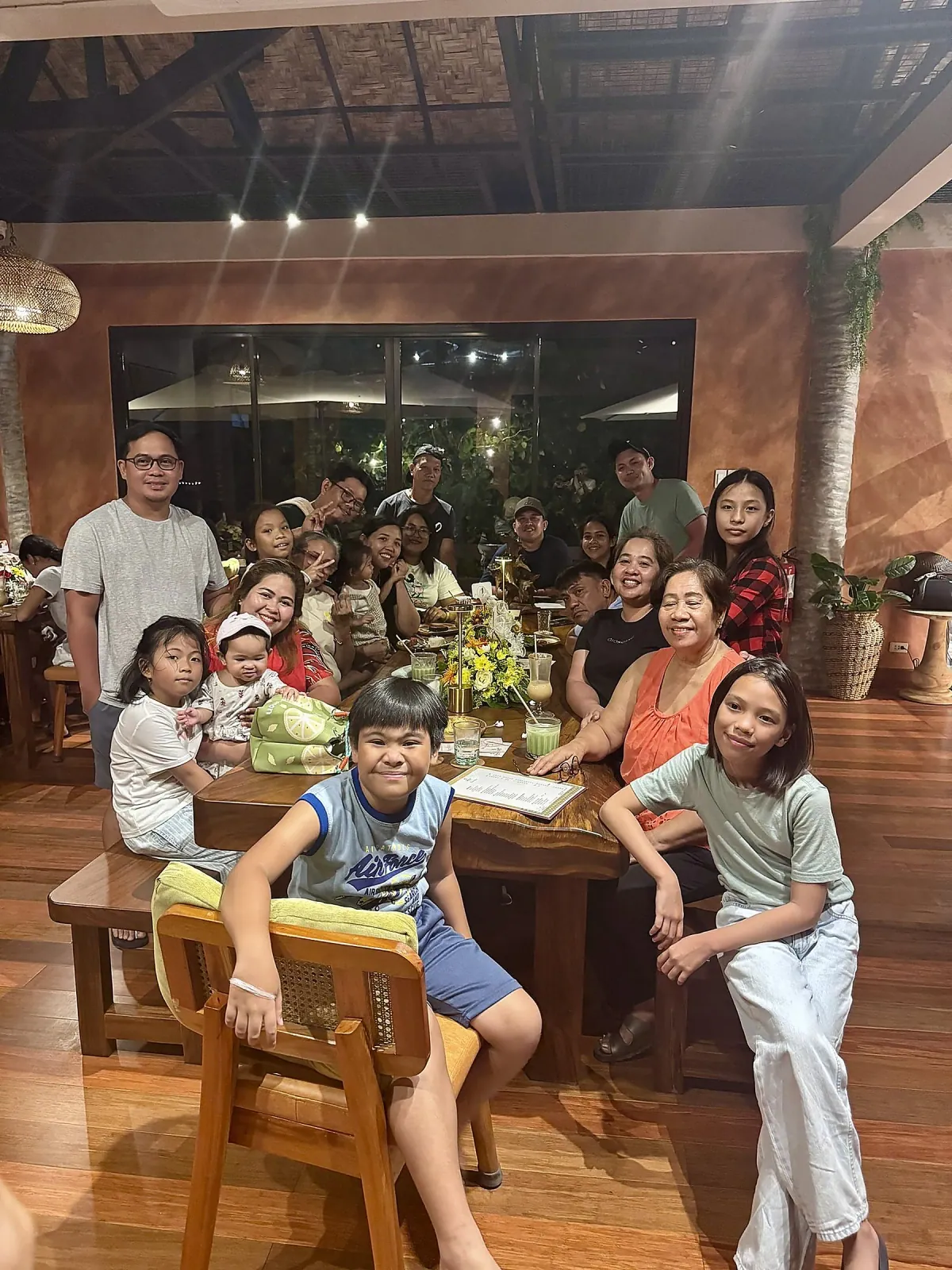 Multi-generational family gathered around a big table at SANA Cafe